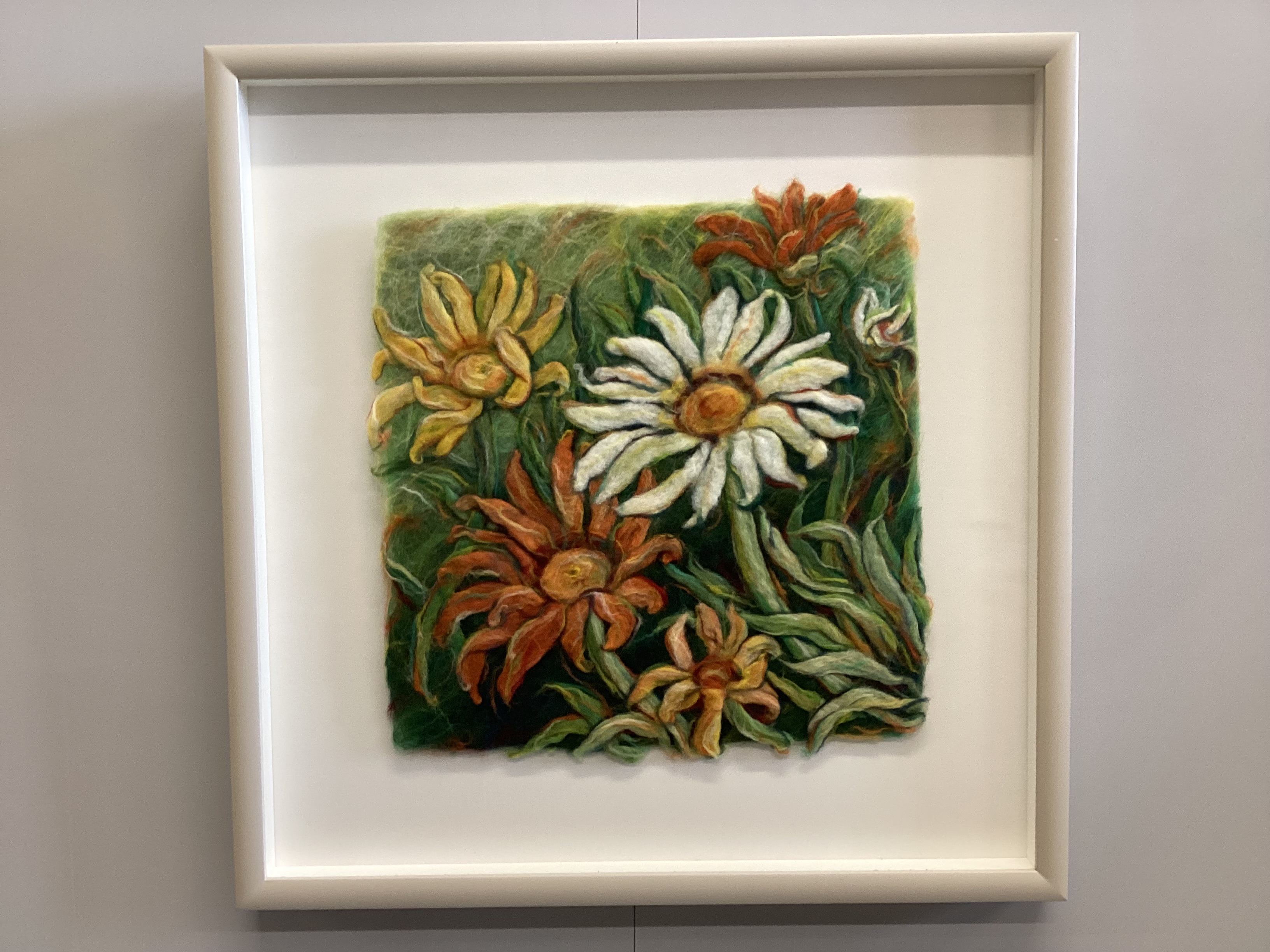 A framed velvet panel fragment and a framed floral woolwork panel, larger 38 x 59cm